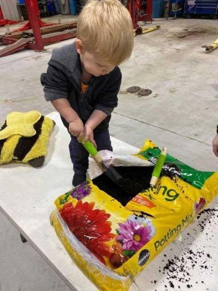 Girl assembling bird feeder